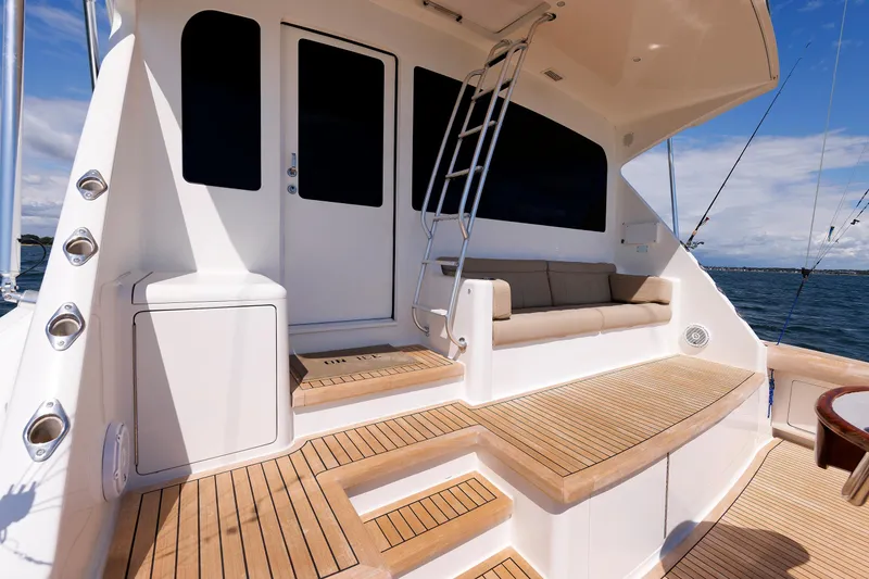 Slide: The Image of Luxurious 2009 Viking 74 Enclosed Bridge yacht deck with seating and ocean view. - 45