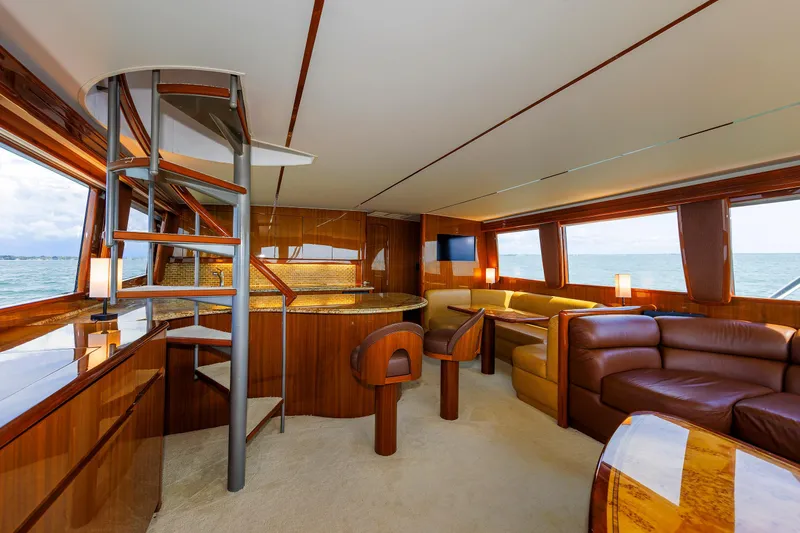 Slide: The Image of Luxurious interior of 2009 Viking 74 Enclosed Bridge yacht with elegant wood finishes and seating. - 59