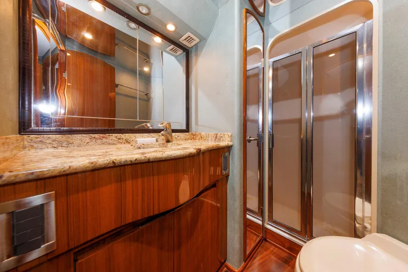 Slide: The Image of Luxurious bathroom in 2009 Viking 74 Enclosed Bridge yacht with wood accents and modern fixtures. - 87