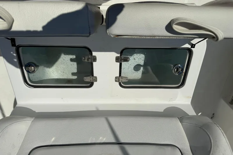 Slide: The Image of 2015 Sea Hunt Gamefish 27 boat interior with storage compartments and cushioned seating. - 14