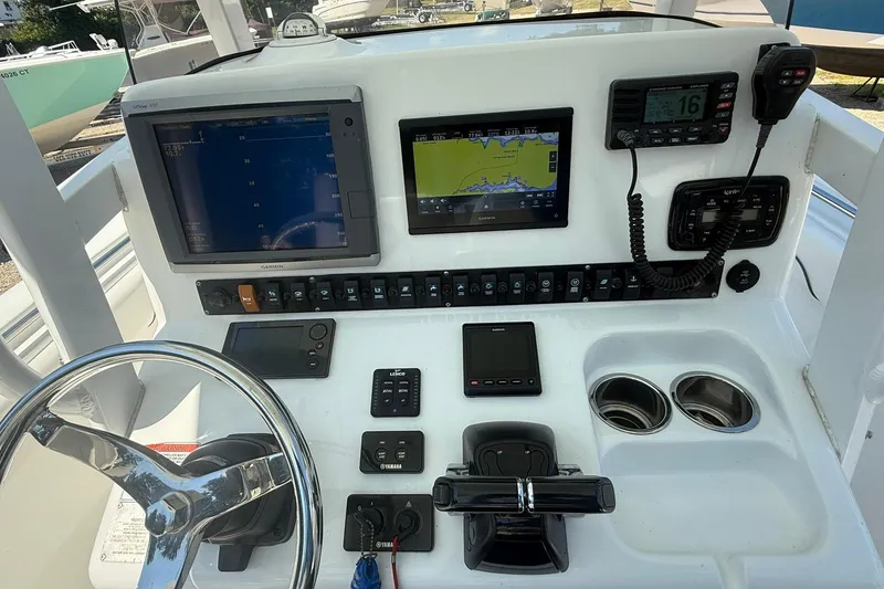 Slide: The Image of 2015 Sea Hunt Gamefish 27 dashboard with navigation screens and controls. - 15