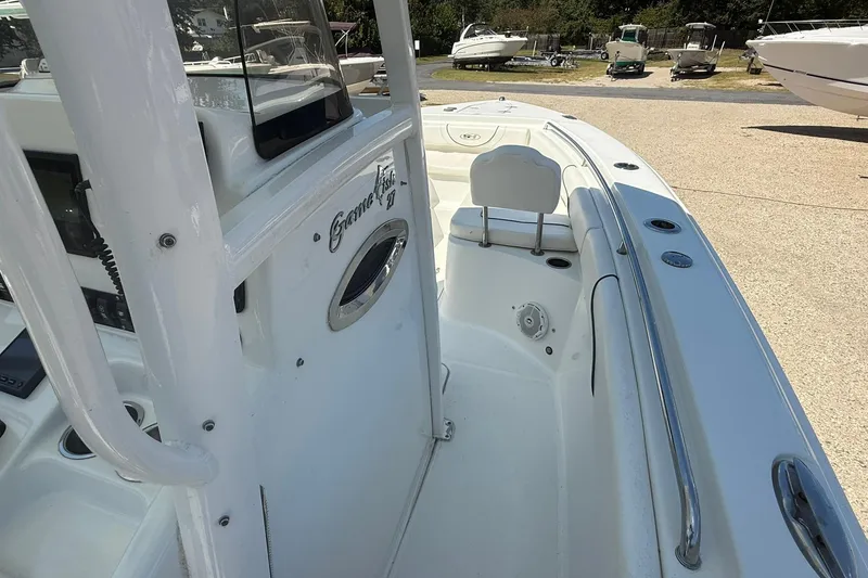 Slide: The Image of 2015 Sea Hunt Gamefish 27 boat interior, featuring seating and control panel. - 16
