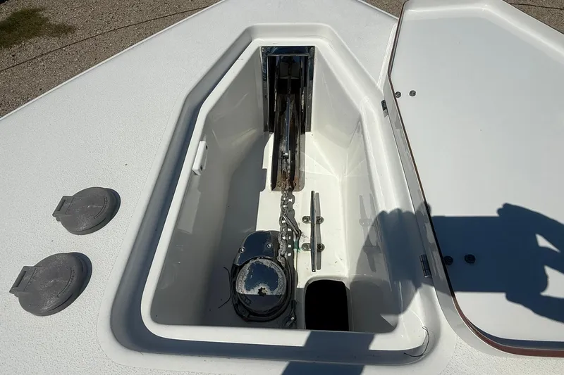 Slide: The Image of Anchor compartment of 2015 Sea Hunt Gamefish 27 boat, open hatch view. - 27