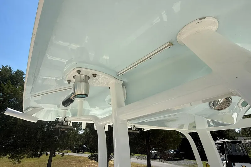 Slide: The Image of 2015 Sea Hunt Gamefish 27 boat T-top with mounted lights and rod holders. - 28