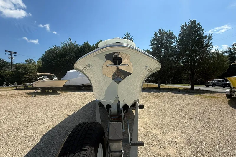 Slide: The Image of 2015 Sea Hunt Gamefish 27 boat on trailer, parked outdoors under clear sky. - 4