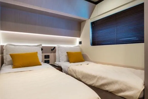 Slide: The Image of Luxurious twin cabin in 2024 Azimut S7 yacht with modern decor and cozy bedding. - 16
