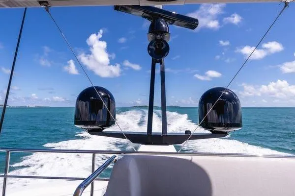 Slide: The Image of 2024 Azimut S7 yacht cruising on open sea under clear blue sky. - 25