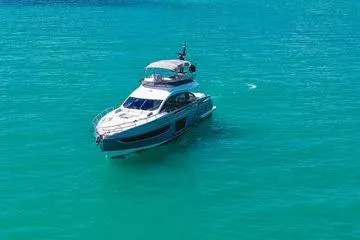 Slide: The Image of 2024 Azimut S7 yacht cruising on clear turquoise waters. - 3