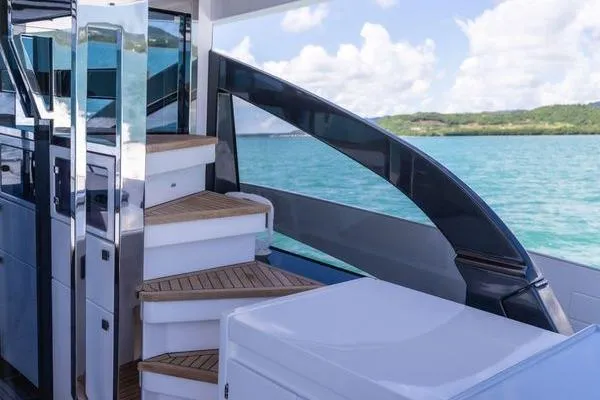 Slide: The Image of 2024 Azimut S7 yacht with elegant staircase and scenic ocean view. - 7