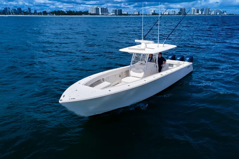 Slide: The Image of 2018 Jupiter 38 FS boat cruising on open water with city skyline in background. - 10