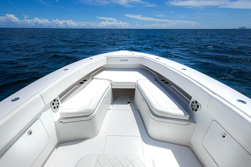 Slide: The Image of 2018 Jupiter 38 FS boat interior with white seating, on open ocean under blue sky. - 15