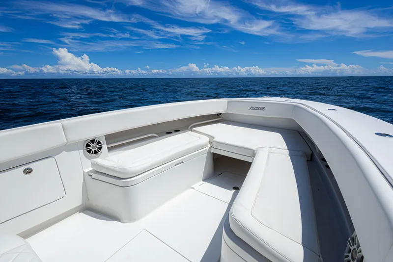 Slide: The Image of 2018 Jupiter 38 FS boat interior with white seating, ocean view, and blue sky. - 16