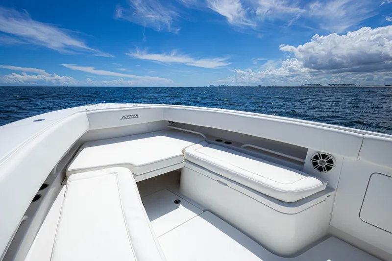 Slide: The Image of 2018 Jupiter 38 FS boat interior with white seating, ocean view, and blue sky. - 17