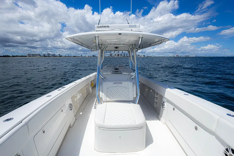 Slide: The Image of 2018 Jupiter 38 FS boat on open water, clear sky, city skyline in background. - 18