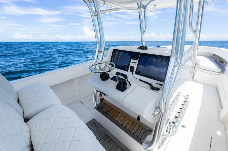 Slide: The Image of 2018 Jupiter 38 FS boat cockpit with modern controls, steering wheel, and ocean view. - 19