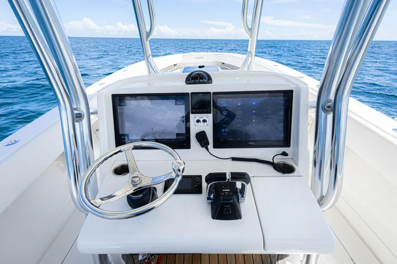 Slide: The Image of 2018 Jupiter 38 FS boat console with dual screens and steering wheel on open sea. - 21