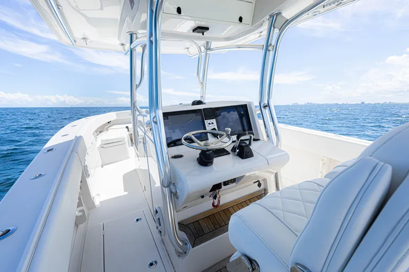 Slide: The Image of 2018 Jupiter 38 FS boat interior with steering console, open sea view, and clear sky. - 25
