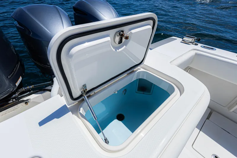 Slide: The Image of 2018 Jupiter 38 FS boat with open storage compartment, twin engines, and ocean backdrop. - 34