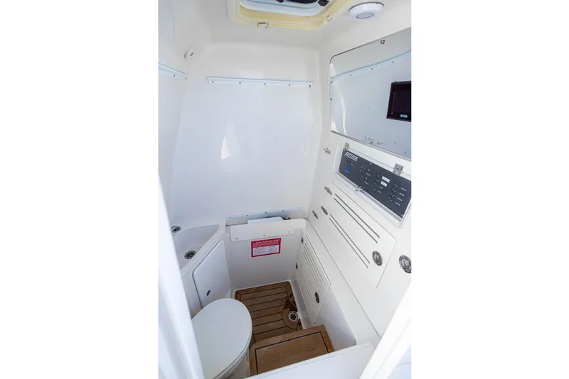 Slide: The Image of Interior of 2018 Jupiter 38 FS boat, featuring a compact marine bathroom with control panel. - 40