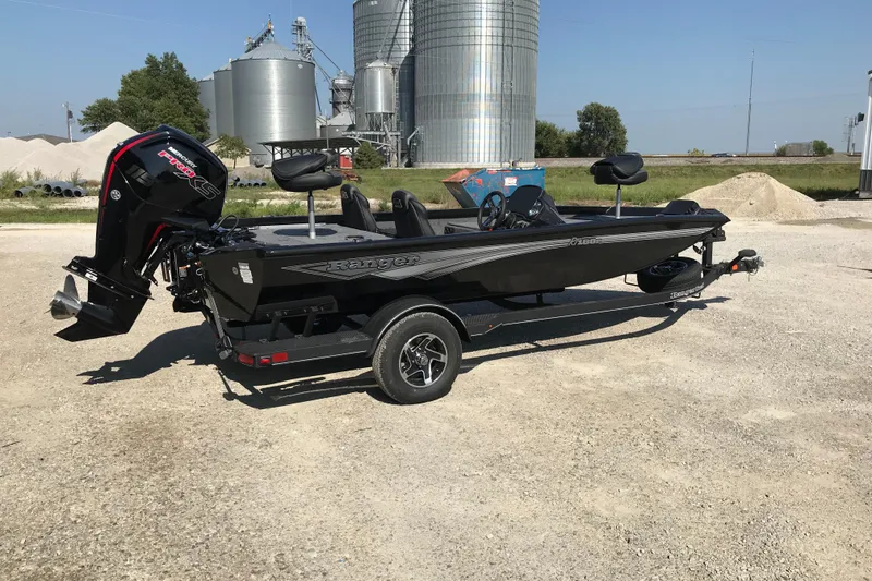 Slide: The Image of 2026 Ranger RT188P fishing boat on trailer outside a metal building. - 2