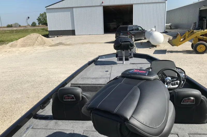 Slide: The Image of 2026 Ranger RT188P boat on trailer, parked outdoors near industrial area. - 5