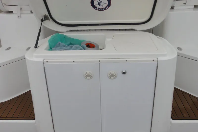 Slide: The Image of 2002 Rampage 30 Open boat storage compartment with open lid and towels inside. - 12