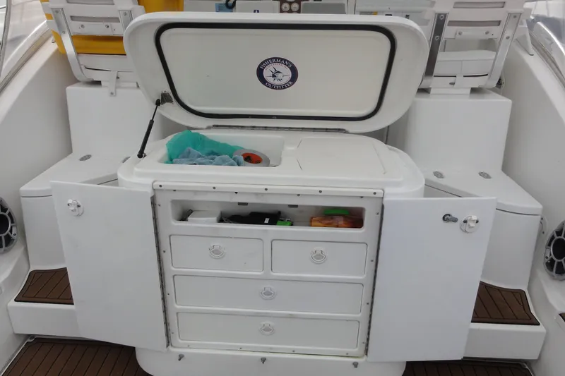 Slide: The Image of 2002 Rampage 30 Open boat interior with storage compartments and seating. - 13