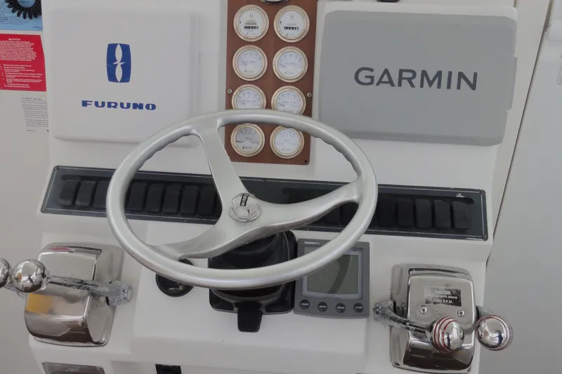 Slide: The Image of Control panel of 2002 Rampage 30 Open boat with Garmin and Furuno equipment. - 14