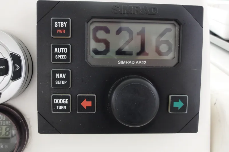 Slide: The Image of Simrad AP22 autopilot control on 2002 Rampage 30 Open boat dashboard. - 17