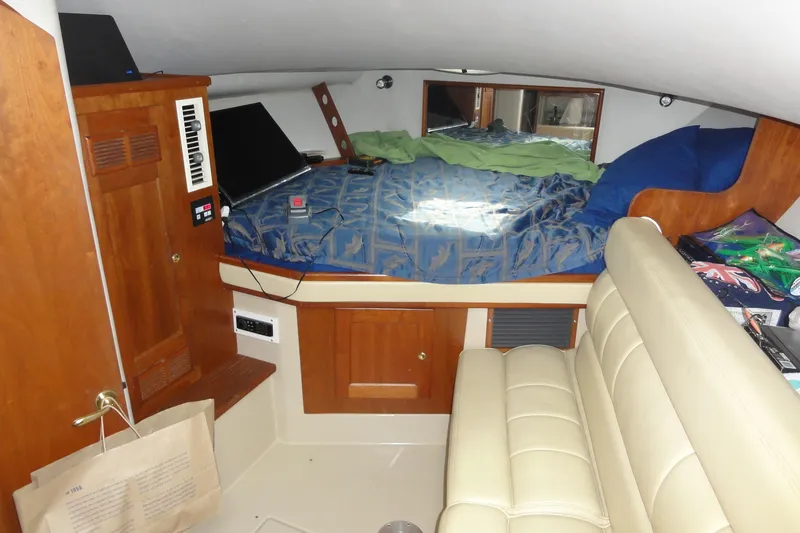 Slide: The Image of Interior of 2002 Rampage 30 Open boat with bed, seating, and wooden cabinetry. - 21