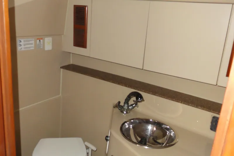 Slide: The Image of 2002 Rampage 30 Open yacht bathroom with sink and toilet. - 22