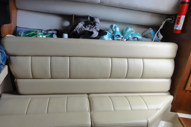 Slide: The Image of Beige leather seating with storage on a 2002 Rampage 30 Open boat interior. - 24