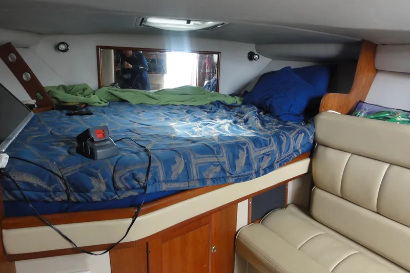 Slide: The Image of Interior cabin of 2002 Rampage 30 Open boat with bed and seating area. - 26