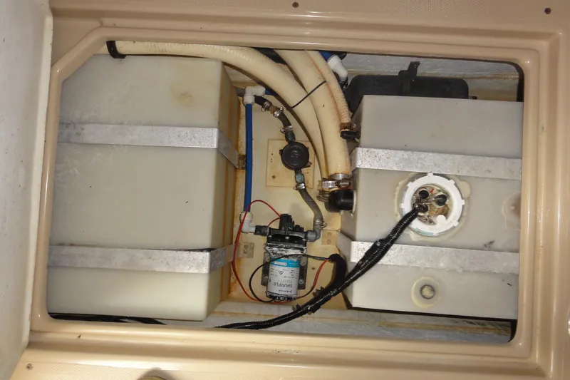 Slide: The Image of 2002 Rampage 30 Open boat interior showing water tanks and plumbing system. - 27
