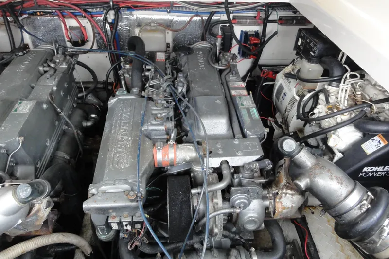 Slide: The Image of Engine room of 2002 Rampage 30 Open boat with visible Yanmar engines and Kohler generator. - 31