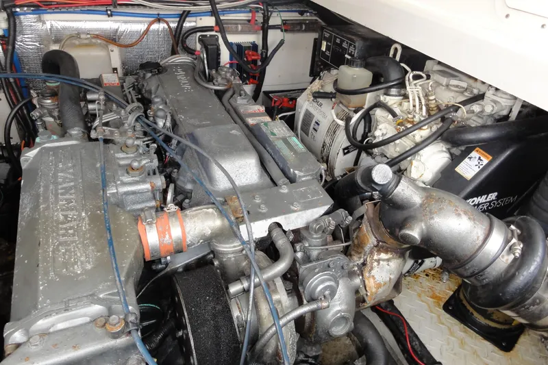 Slide: The Image of Engine room of a 2002 Rampage 30 Open boat, featuring Yanmar and Kohler components. - 32