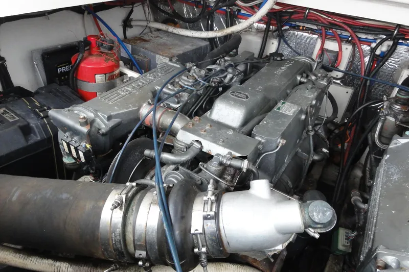 Slide: The Image of Engine compartment of a 2002 Rampage 30 Open boat, featuring detailed mechanical components. - 33