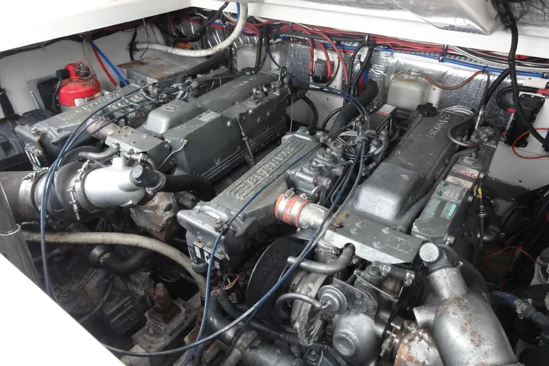Slide: The Image of Engine compartment of a 2002 Rampage 30 Open boat, featuring dual diesel engines. - 34