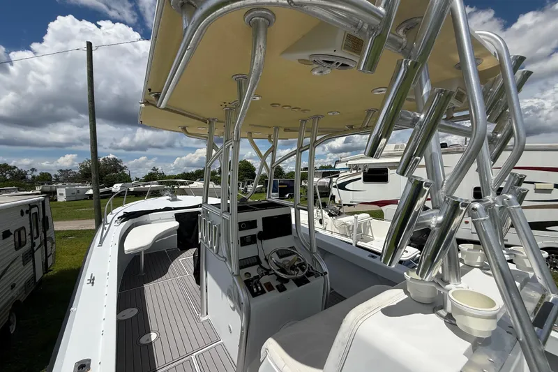 Slide: The Image of 1981 T Craft Gulfstream 30 boat with helm, rod holders, and seating under a cloudy sky. - 25