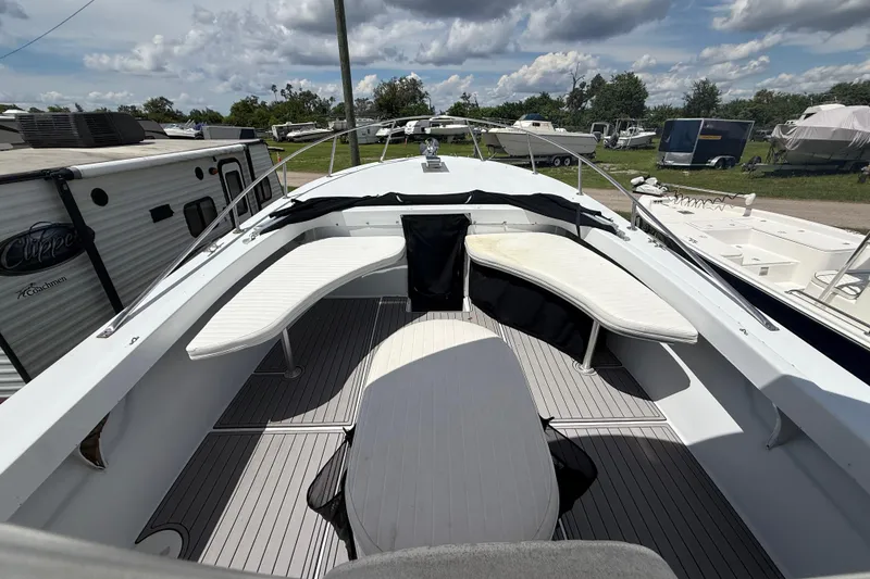 Slide: The Image of 1981 T Craft Gulfstream 30 boat interior with seating, docked outdoors under cloudy sky. - 35
