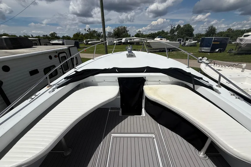 Slide: The Image of 1981 T Craft Gulfstream 30 boat deck with seating, surrounded by trailers and boats. - 39