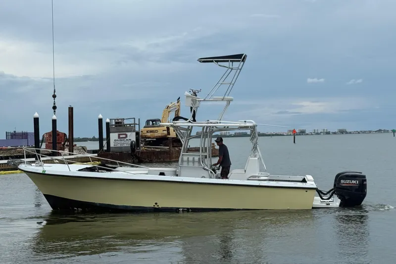 Slide: The Image of 1981 T Craft Gulfstream 30 boat with Suzuki outboard motor on calm water. - 4