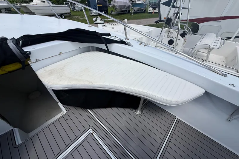 Slide: The Image of 1981 T Craft Gulfstream 30 boat with white seating and deck, docked outdoors. - 43