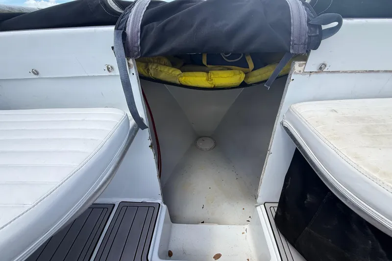 Slide: The Image of 1981 T Craft Gulfstream 30 boat interior with white seating and storage area. - 44