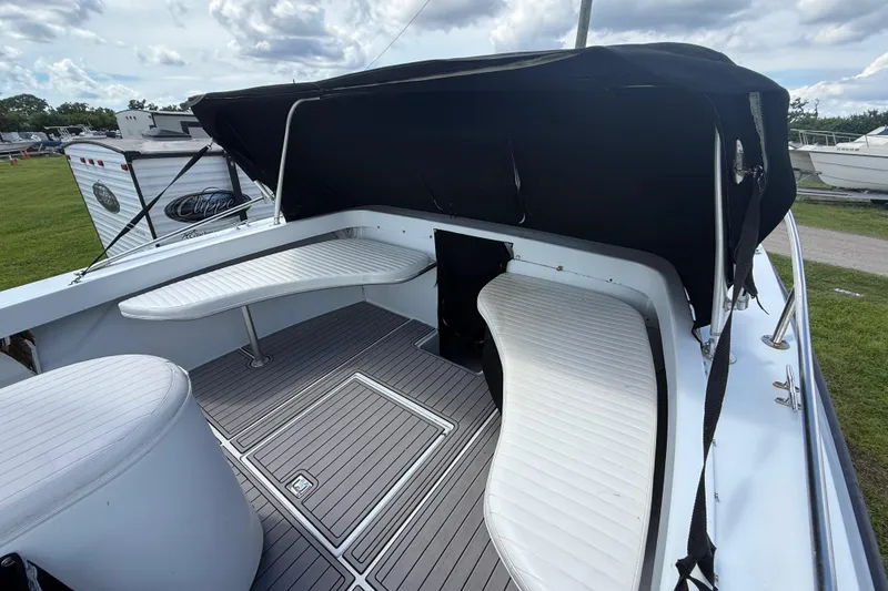 Slide: The Image of 1981 T Craft Gulfstream 30 boat interior with cushioned seating and canopy. - 46