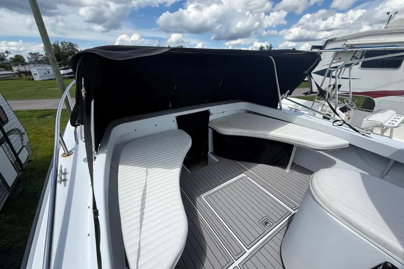 Slide: The Image of 1981 T Craft Gulfstream 30 boat interior with seating and canopy under a cloudy sky. - 48