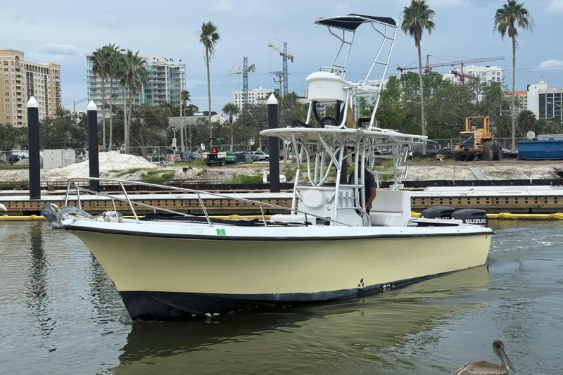 Slide: The Image of 1981 T Craft Gulfstream 30 boat docked in urban marina with palm trees and buildings. - 5