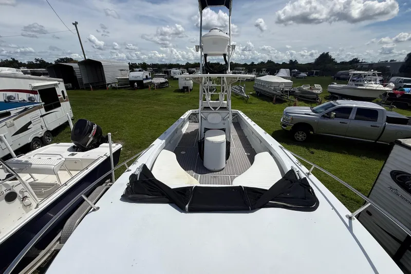 Slide: The Image of 1981 T Craft Gulfstream 30 boat in outdoor storage, surrounded by vehicles and trailers. - 53