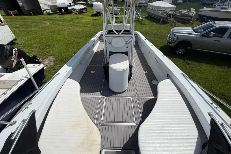 Slide: The Image of 1981 T Craft Gulfstream 30 boat with spacious deck and seating, parked on grass. - 55