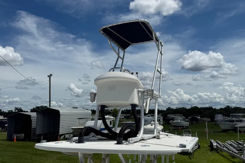 Slide: The Image of 1981 T Craft Gulfstream 30 boat with elevated helm, parked under a cloudy sky. - 56